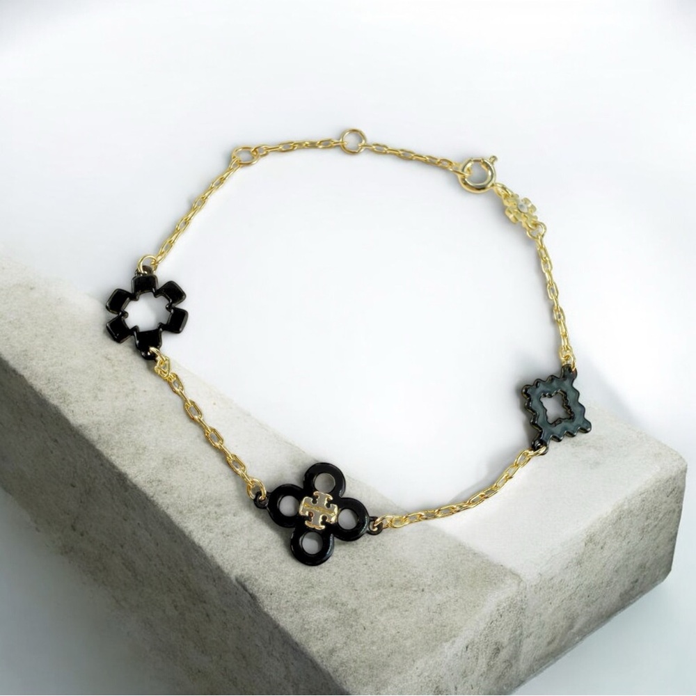 Tory Burch Kira Clover enamel bracelet in gold/black.